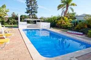 A rectangular swimming pool with a white deck and yellow chairs along one side. - Casa Linda, comfortable villa with private pool (Porches)