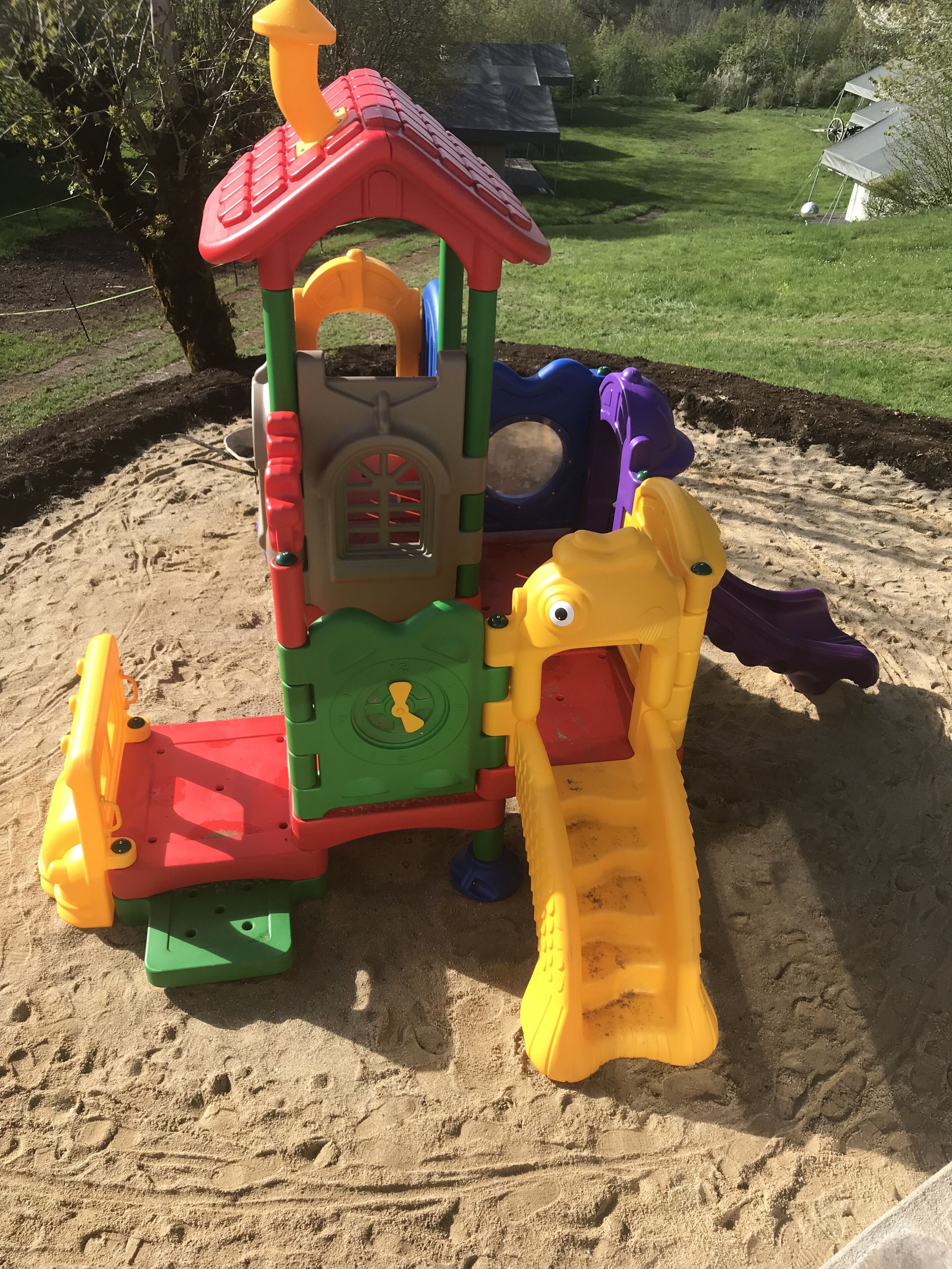 A playground with a climbing structure and a slide.