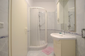 Classic Apartment | Bathroom | Shower, towels, soap, toilet paper
