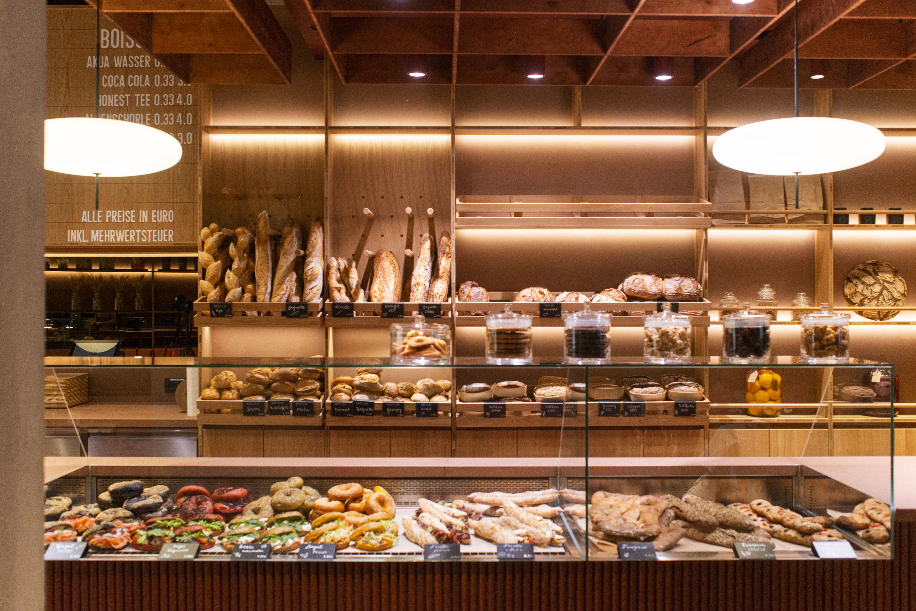 A bakery display with various baked goods and a sign indicating prices in Euros.