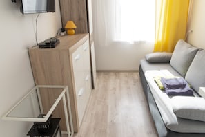 Standard Studio | Living area | 32-inch flat-screen TV with cable channels, TV