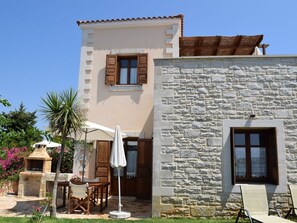 A two-story building with a stone facade and a tiled roof.