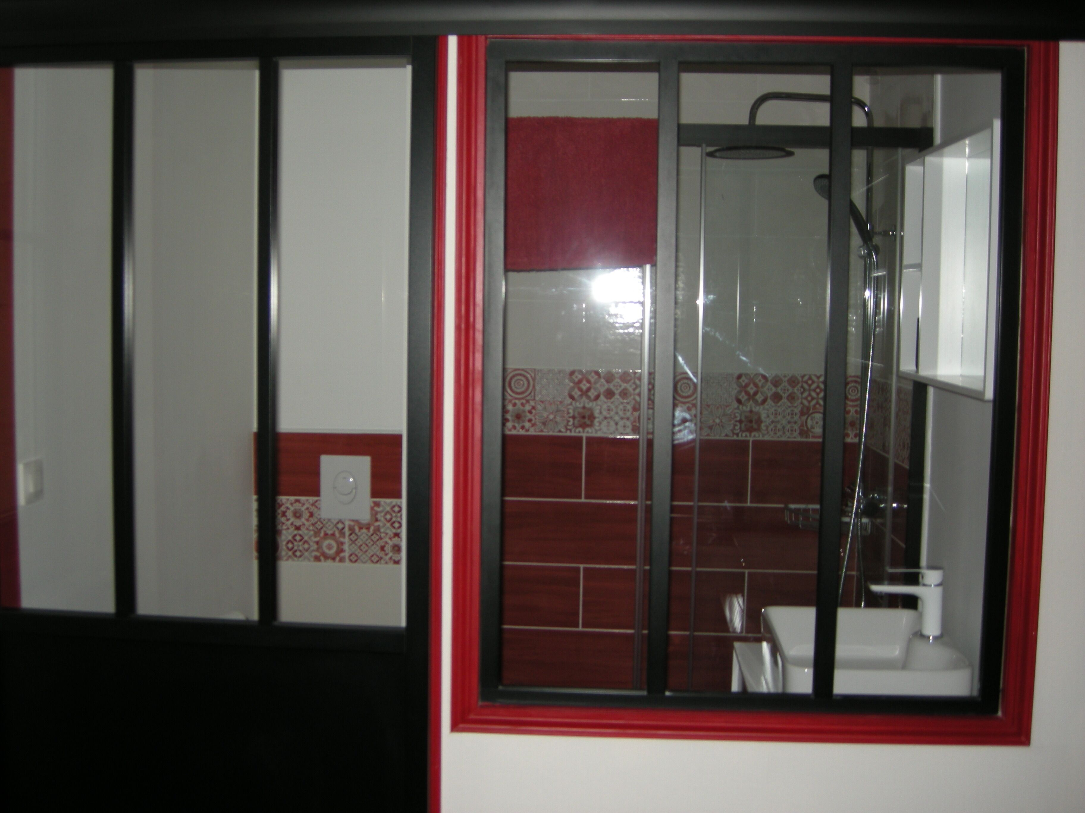 A bathroom with a shower, a sink, and a toilet.