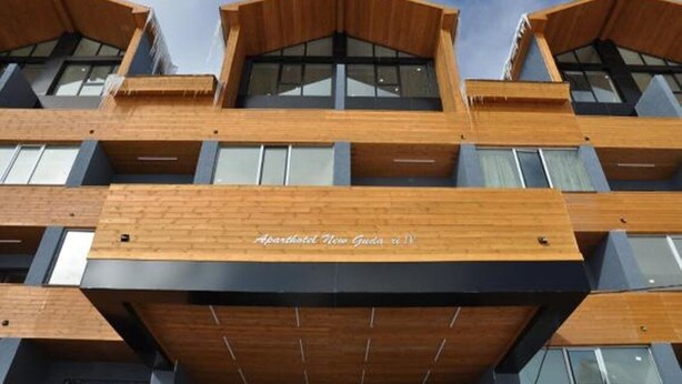 A multi-story hotel with a modern design, featuring wooden paneling and large windows. - New Gudauri Block 4 - Ski4Life (Kazbegi)