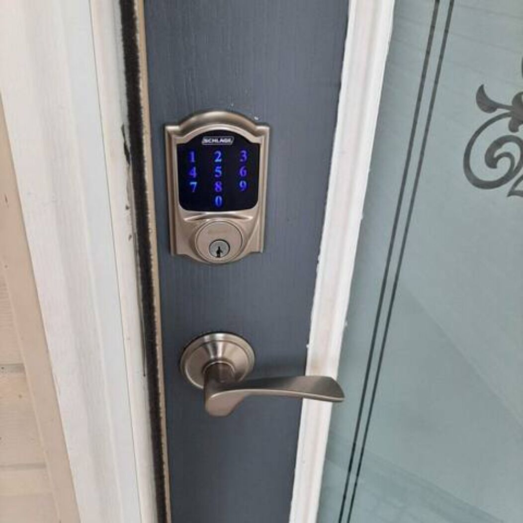 A door with a numeric keypad lock and a lever handle.