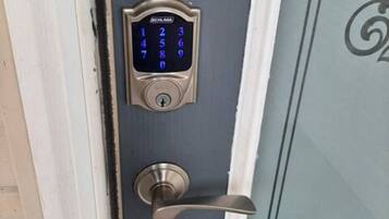 A door with a numeric keypad lock and a lever handle.