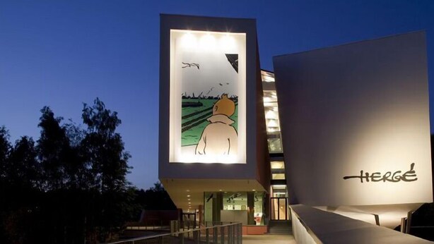 A modern building with a large illuminated sign featuring a cartoon character and the word "HERGE". - Residence la Fraisiere (Brussels)