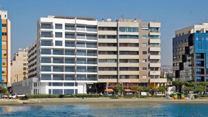 A multi-story hotel with a modern facade, located near a waterfront.