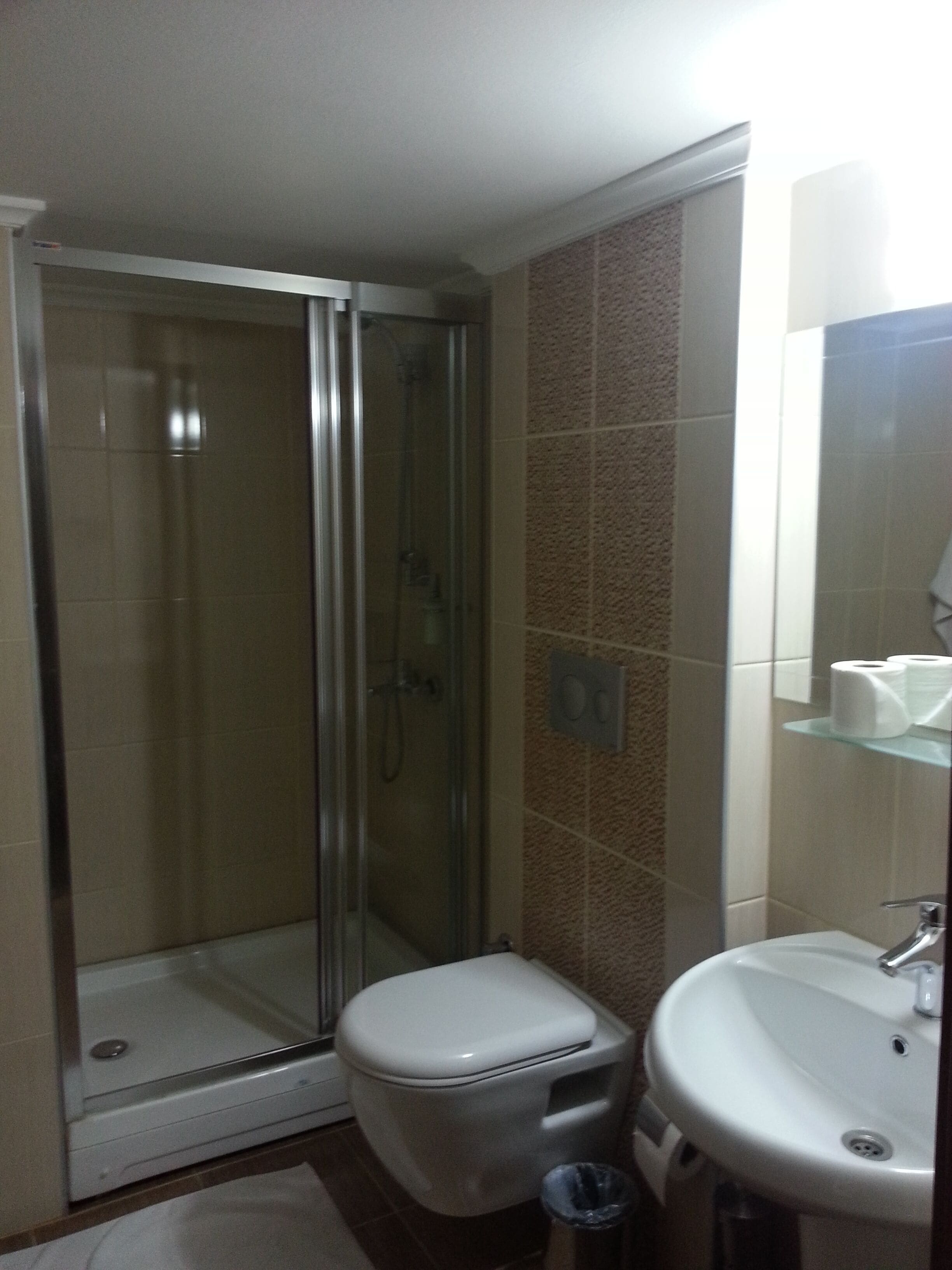 shower, hair dryer, slippers, towels