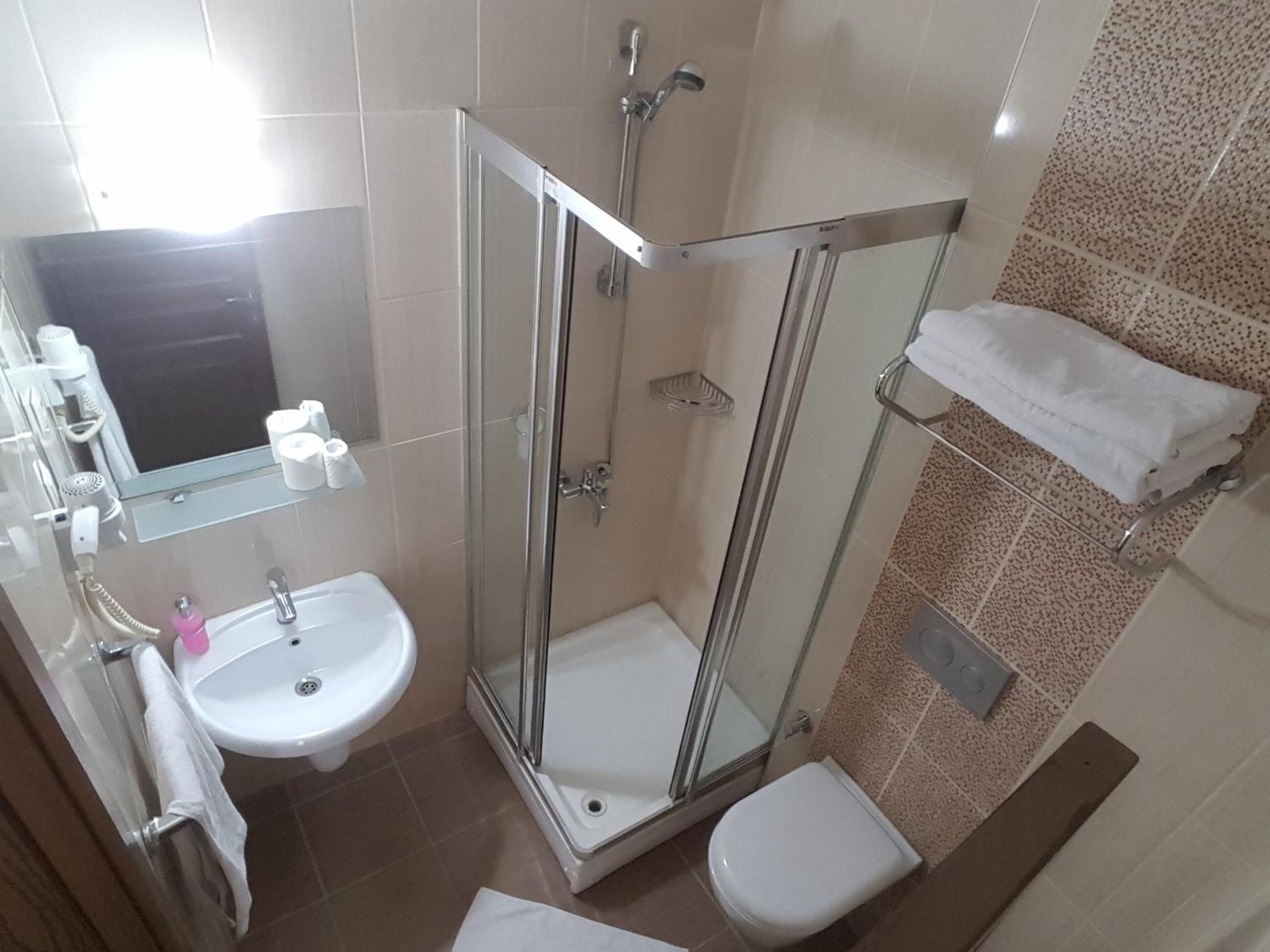 shower, hair dryer, slippers, towels