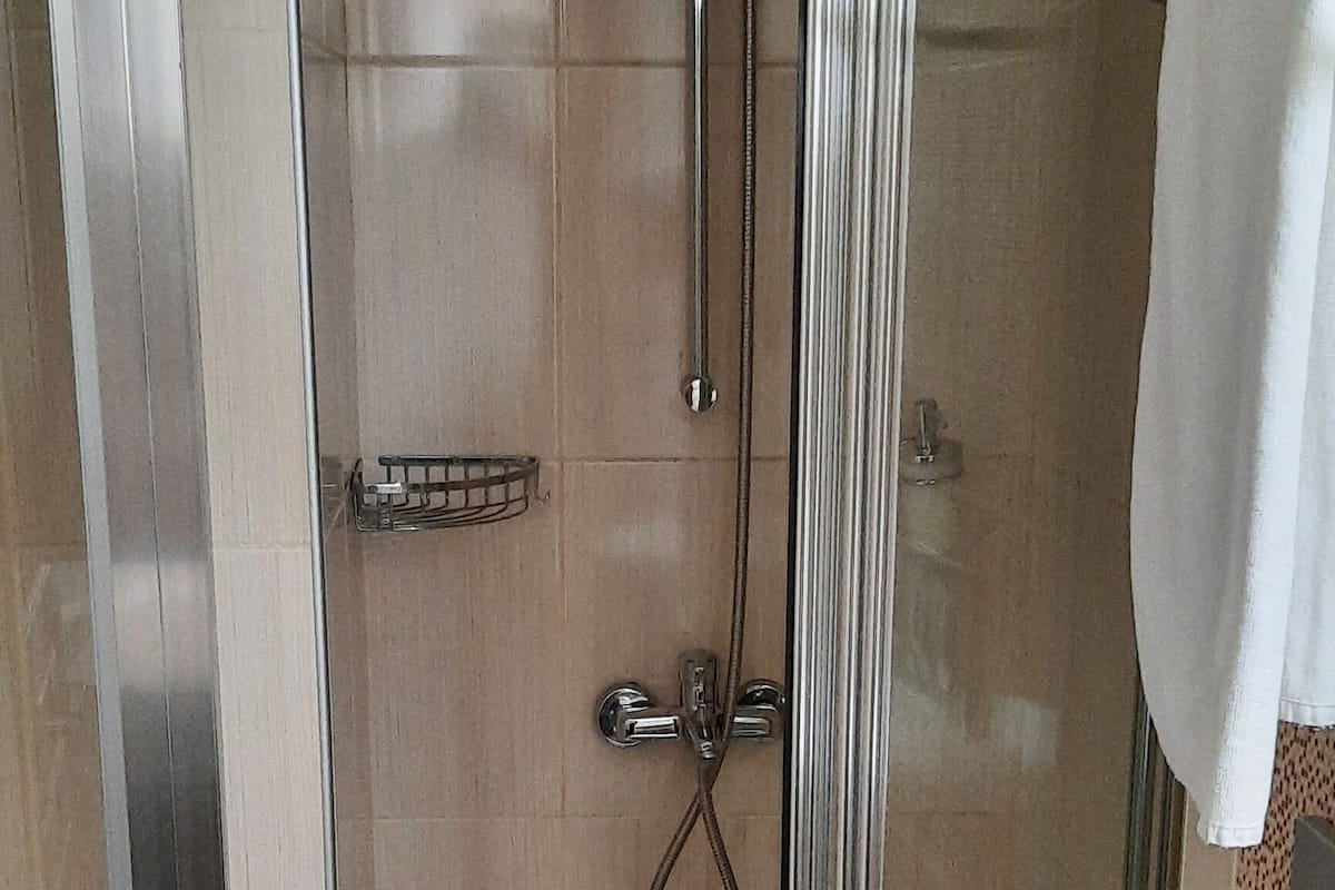 single room | bathroom | shower, hair dryer, slippers, towels