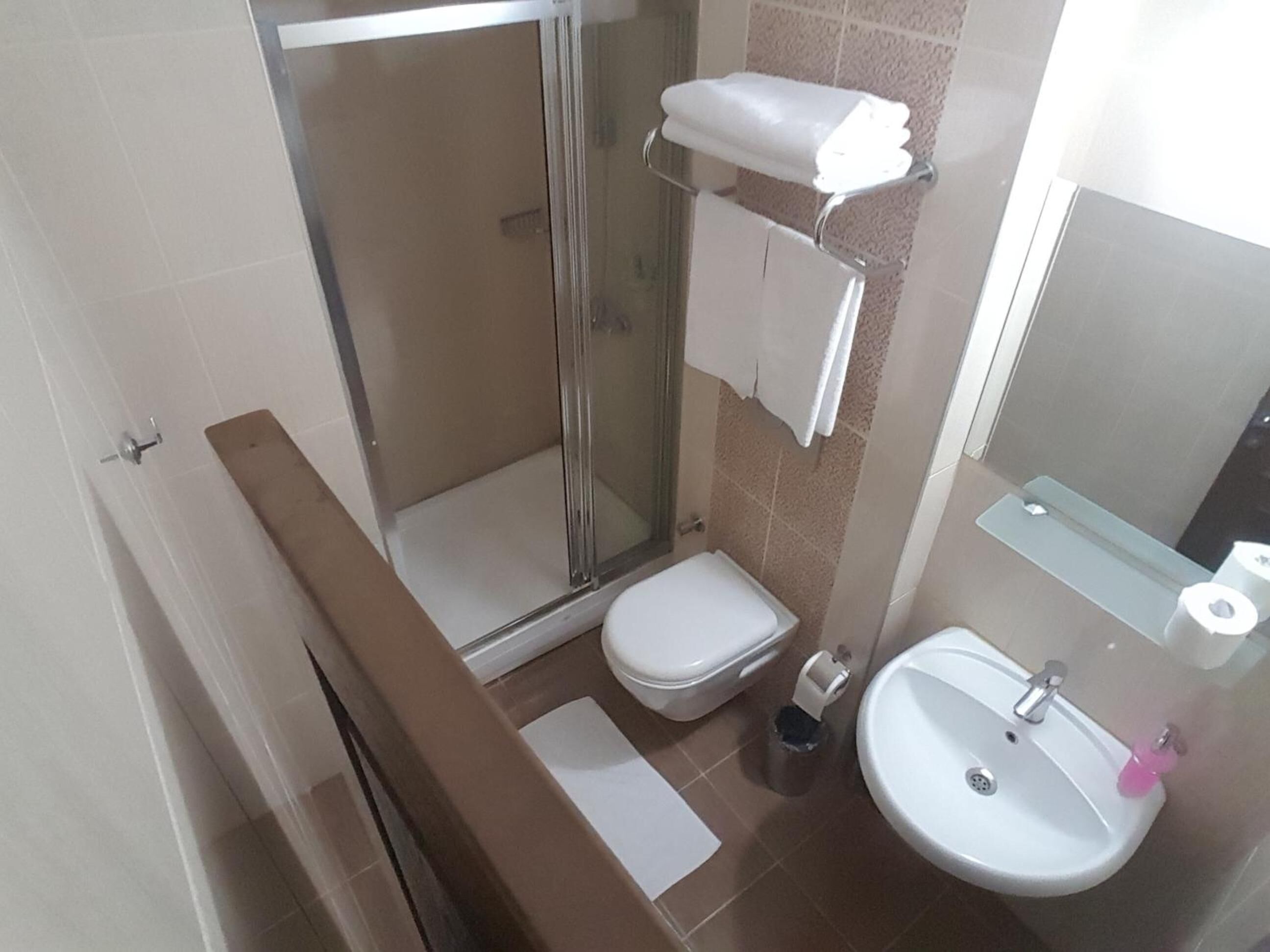 shower, hair dryer, slippers, towels