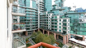 A modern high-rise building with multiple balconies and a glass facade. - River view Luxury 3bed flat with views (London)