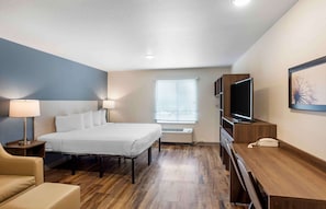 Relax in a stylishly designed room with a comfortable bed, desk, and flat-screen TV.