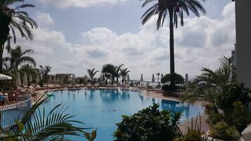 Seasonal outdoor pool, open 8:00 AM to 7:00 PM, pool umbrellas