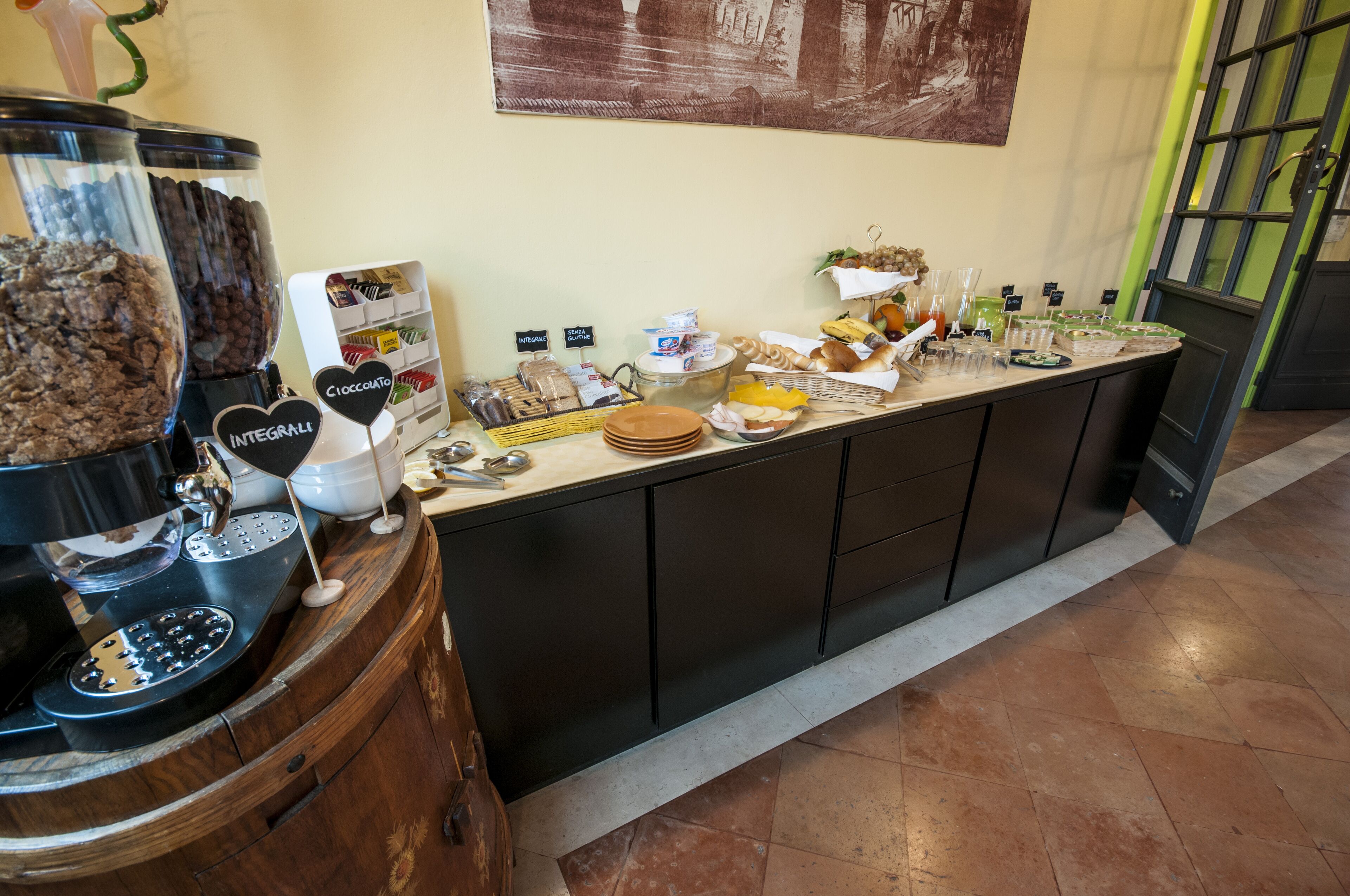 A buffet counter with various food items and a coffee station.