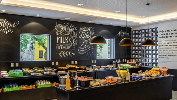 Een modern café in zwart-wit kleurenschema, met een ruim aanbod aan eten en drinken.