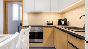 Eine moderne Küche mit Einbauofen, Kaffeemaschine und Toaster.