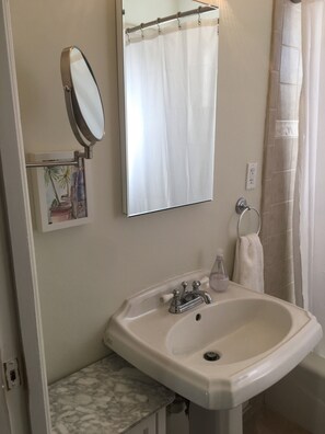 Tina con regadera, secadora de cabello, toallas, jabón 