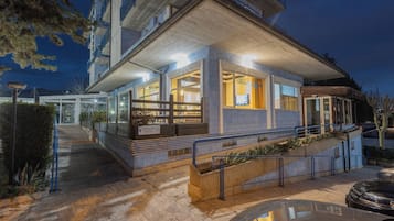Un hotel dal design moderno, con un ingresso ben illuminato, una reception ben visibile e una scala che conduce all'ingresso.
