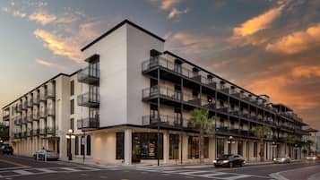 A multi-story hotel with a modern architectural design, featuring balconies and large windows.