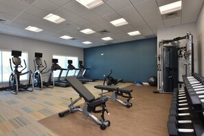A gym with treadmills, elliptical machines, benches, and weightlifting equipment. - Holiday Inn Express & Suites Spring - Woodlands Area by IHG (Spring)