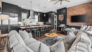 A modern living space with a kitchen, dining area, and seating area. - Two Luxury WeHo Homes w/ Rooftops + 6BR Near DT (Nashville)