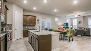 City Townhome | Private kitchen | Full-size fridge, microwave, oven, dishwasher