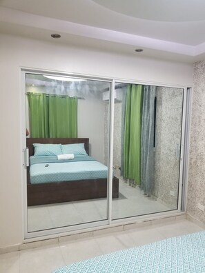 Relax in this serene bedroom with a bed and en-suite shower area.