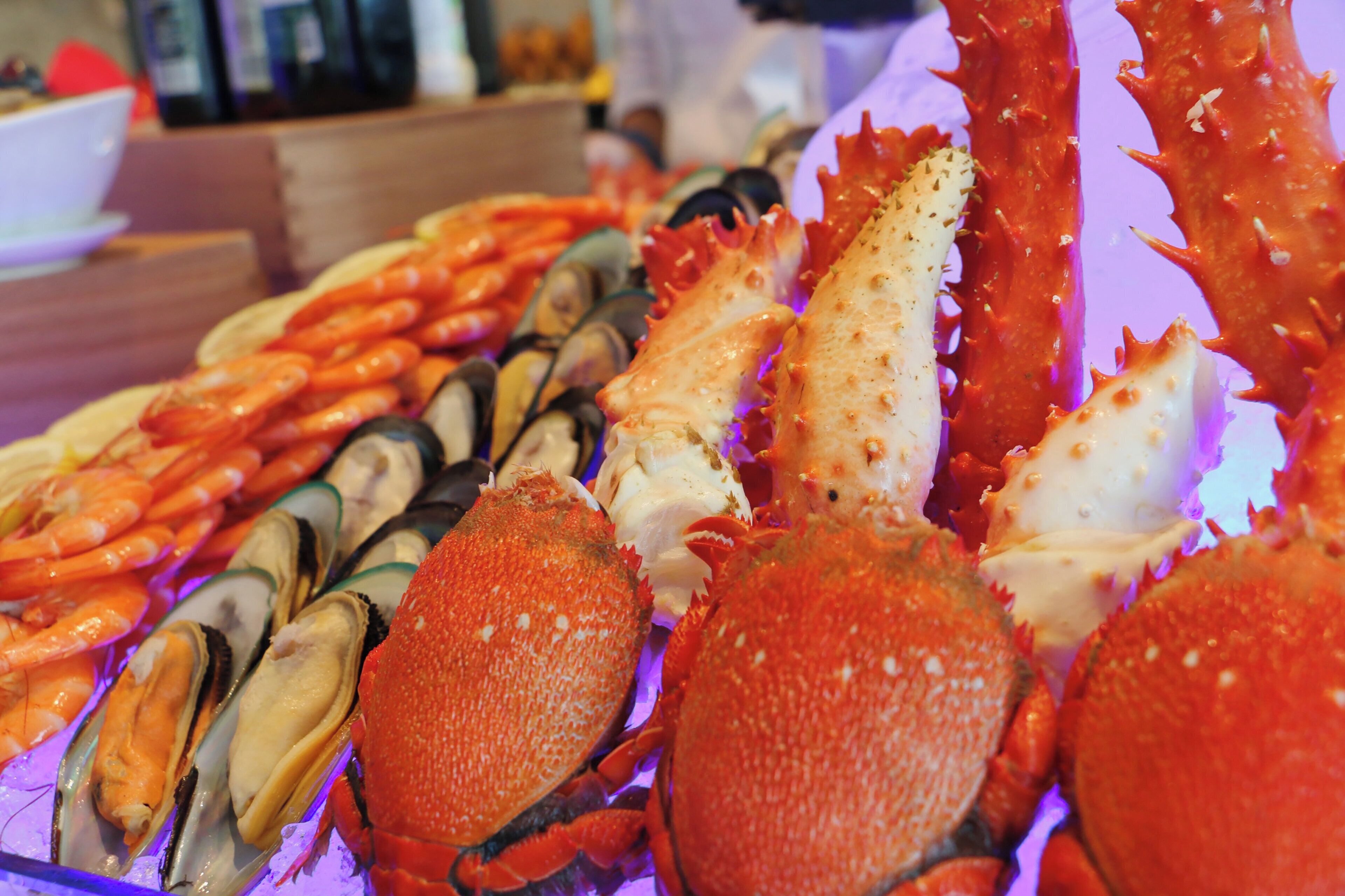 A variety of seafood including crabs and mussels displayed on a table.
