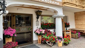 A hotel entrance with a sign reading "Residence Chalet Panorama." - Wellness Residence Panorama - Check-in at  Olympia Hotel (Livinallongo del Col di Lana)