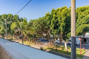 A residential street with houses, trees, and parked cars. - 13 First Avenue Sawtell (Sawtell)