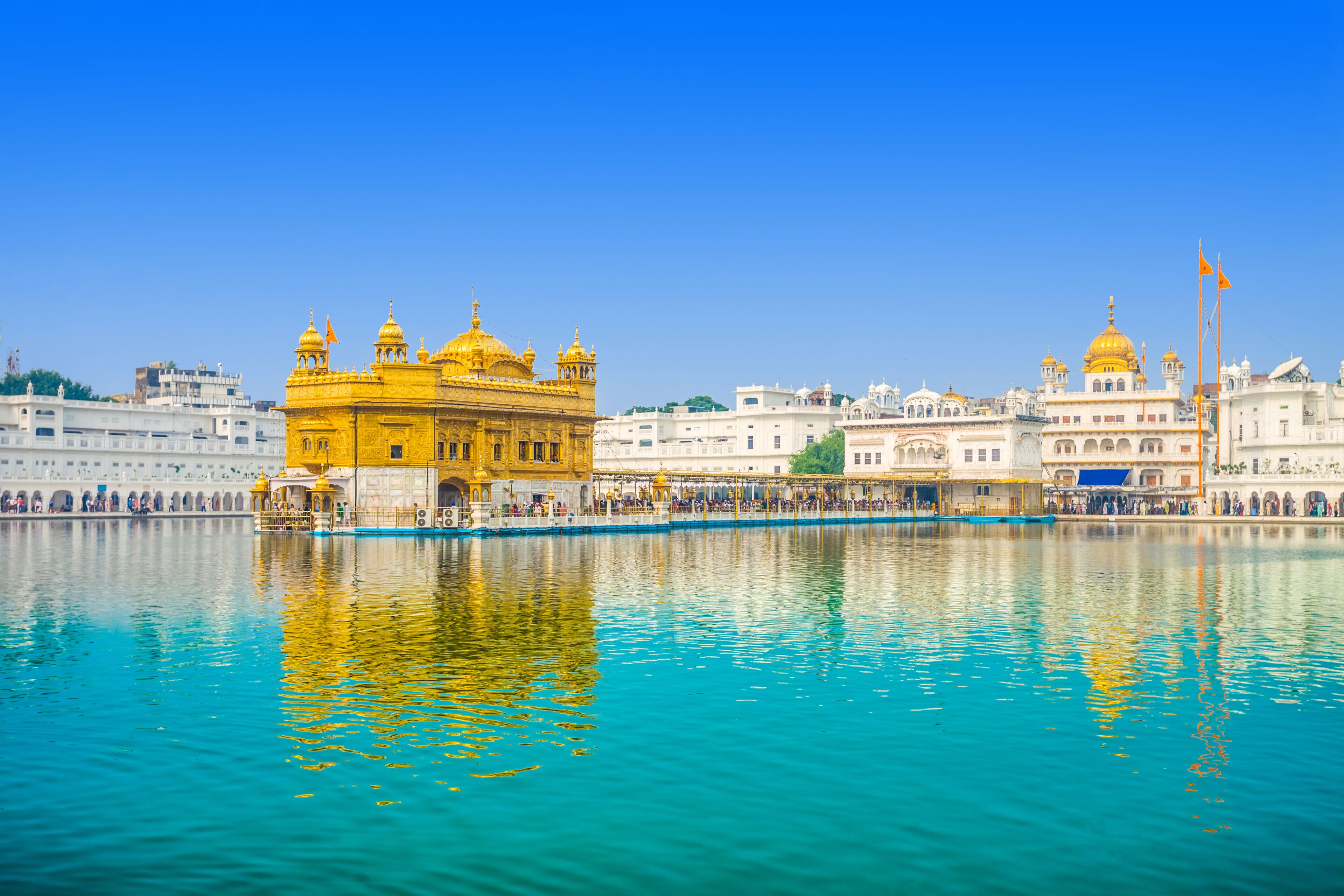 A large, historic building with multiple domes and a prominent golden entrance.