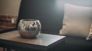 A disco ball on a table in a room with a couch and a brick wall in the background. - Loft apartment in Hollywood (Los Angeles)