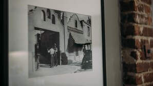 A black and white photograph of a building with a sign that reads "The Keystone Film Co." - Loft apartment in Hollywood (Los Angeles)