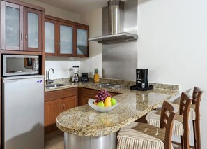 Enjoy cooking and dining in this well-equipped kitchen with a range, sink, and coffee maker.