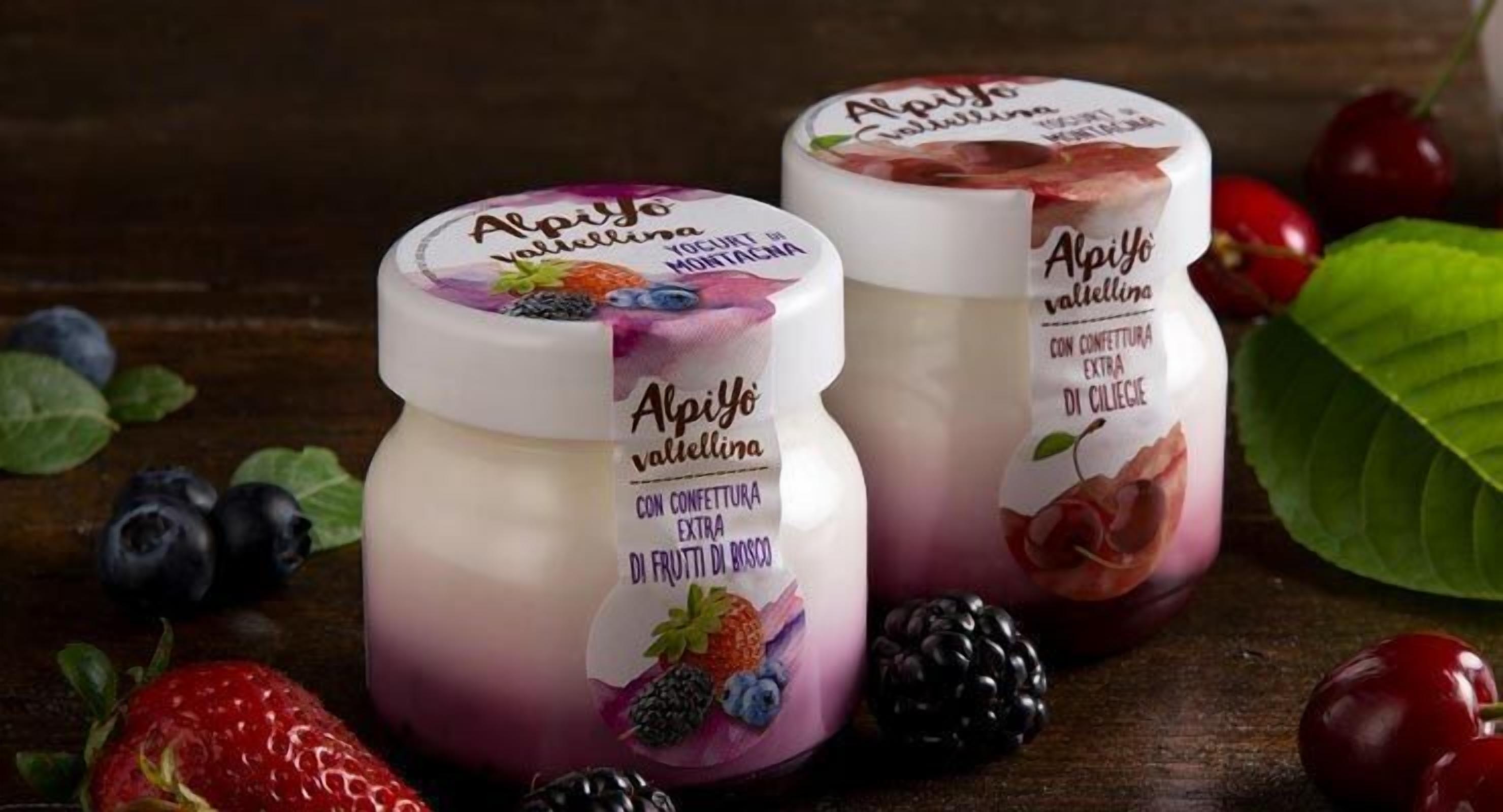 Two containers of Alpiyo yogurt with labels indicating flavors like strawberry and blackberry.