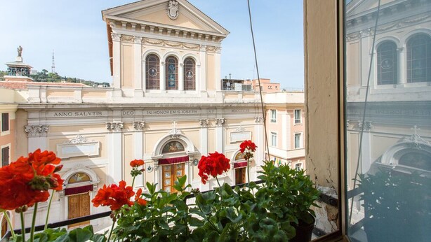A building with classical architecture, including a pediment and arched windows. - St. Joseph apartment 47 (Roma)