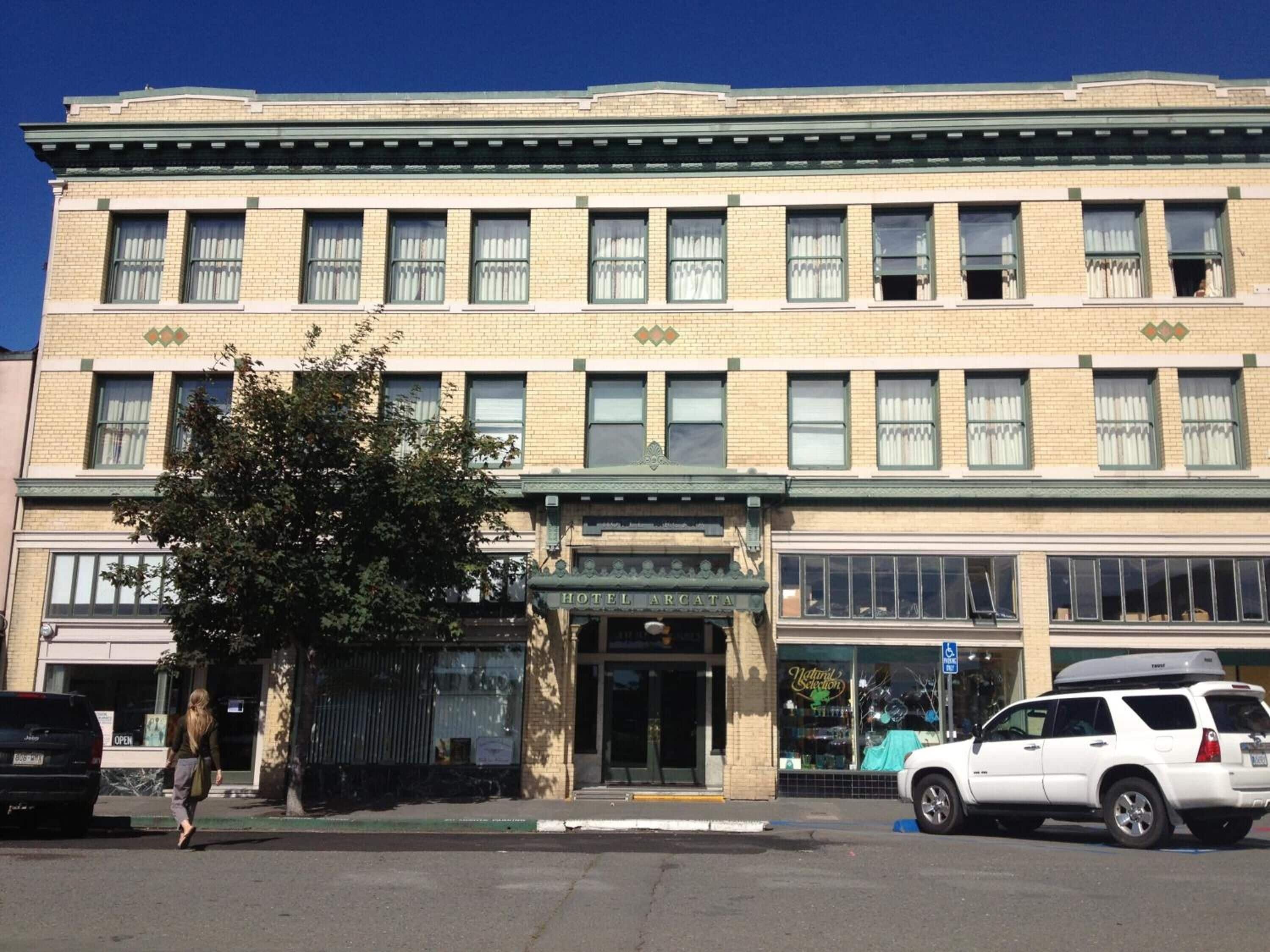 A multi-story hotel with a classic architectural style, featuring a prominent entrance and large windows.