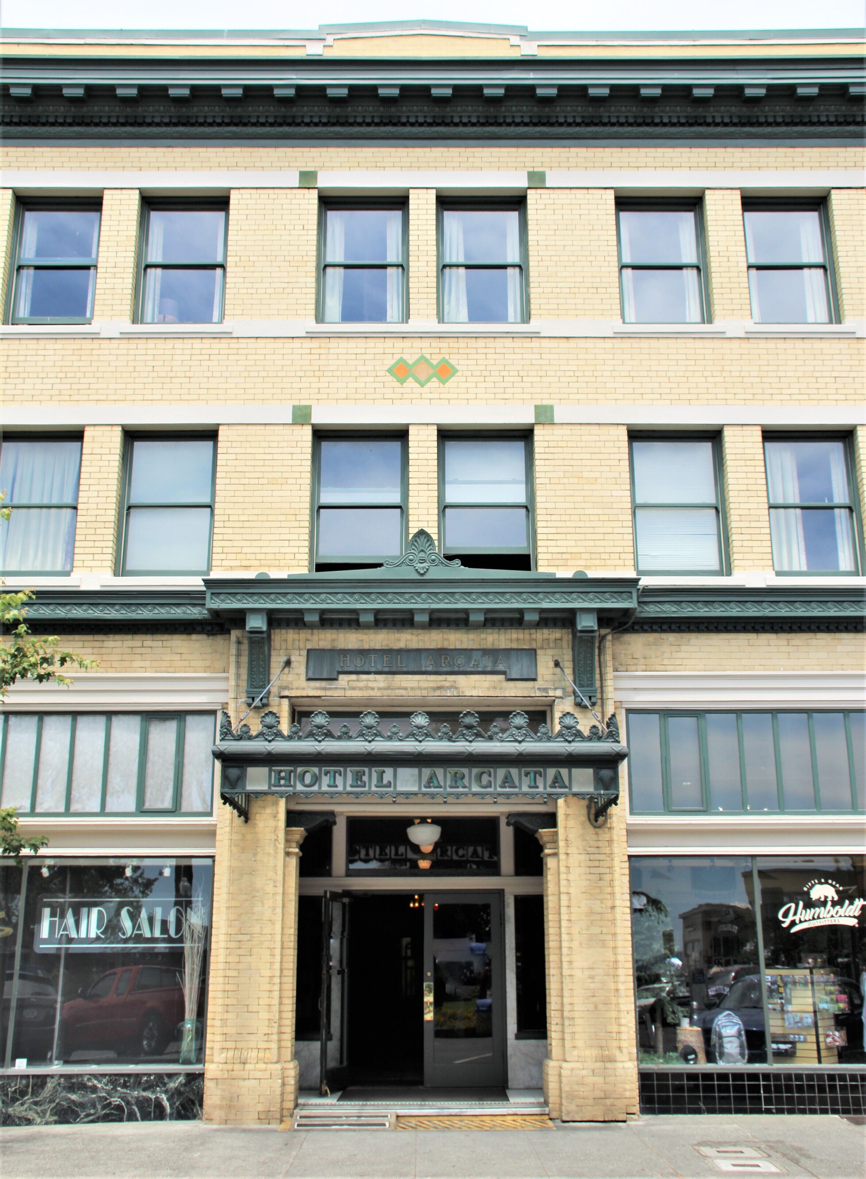 A building with a sign reading "HOTEL ARGATA" and a "HAIR SALO" on the ground floor.