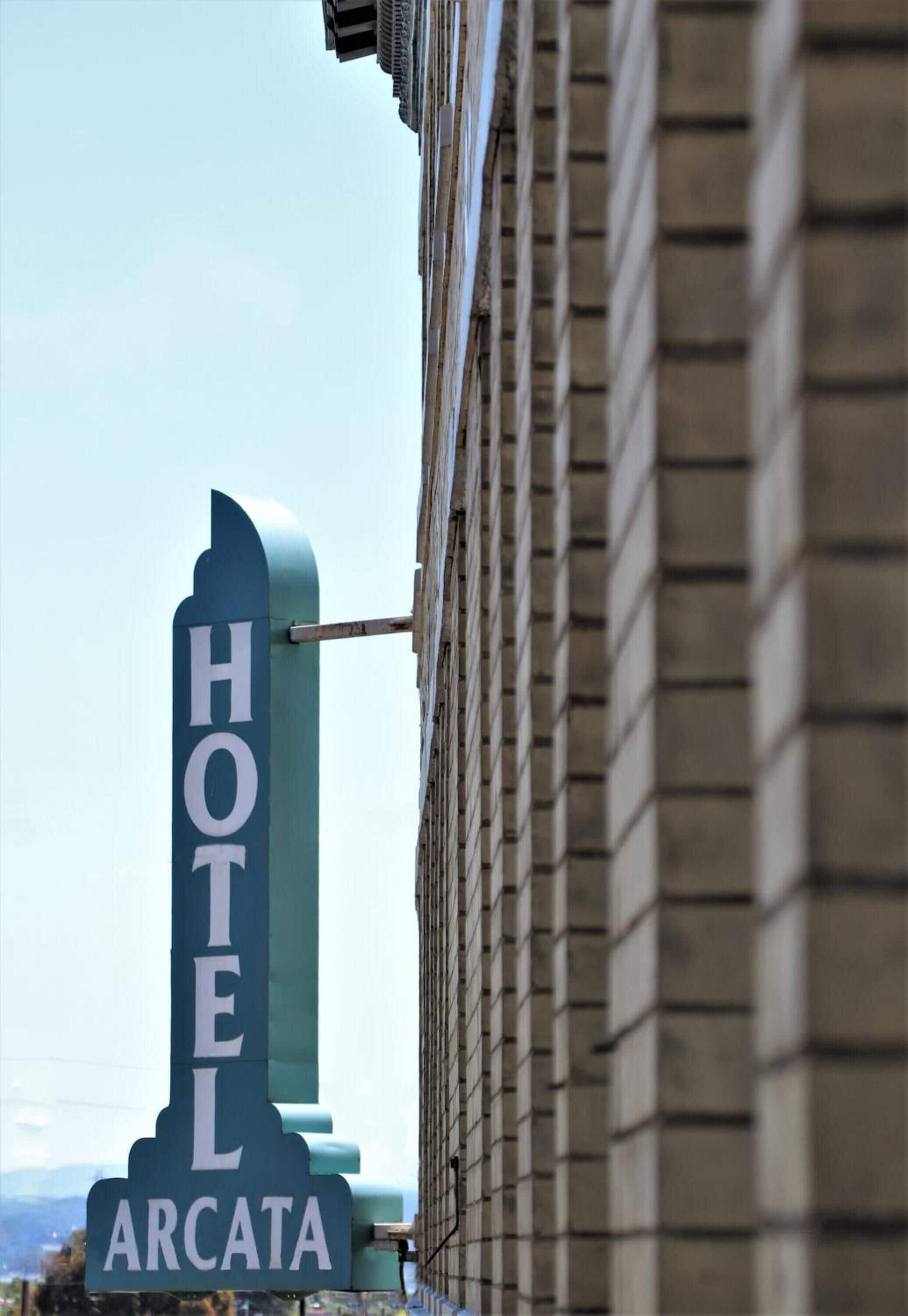 A hotel sign with the name "HOTEL ARCATA" mounted on a building.