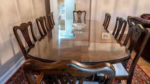 A round glass table surrounded by wooden chairs with a crystal bowl centerpiece. - Forrest's Townhouse -  Two adjoining apartments with shared private hallway (Kendal)