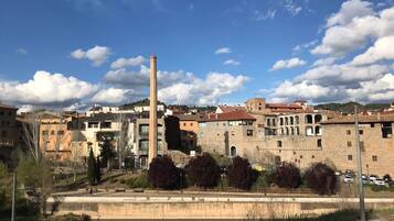 A historic town with a prominent tower, narrow streets, and a river.