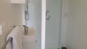 Shower, hair dryer, towels, toilet paper
