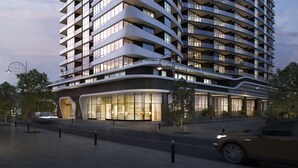 A modern high-rise hotel with curved balconies and large windows. - Domi Serviced Apartments (Glen Waverley)