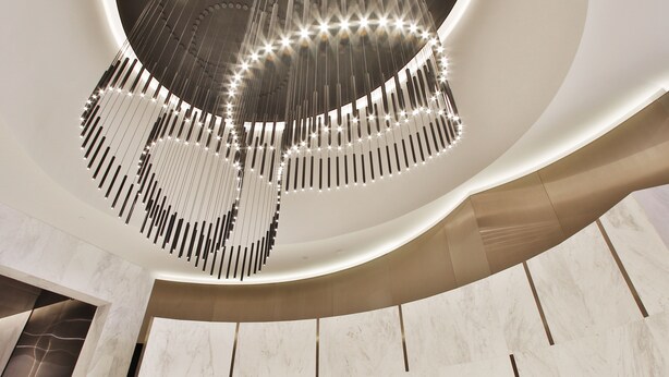A modern interior with a prominent 'GALLERIA' sign, a unique ceiling design with hanging lights, and a curved wall structure. - Domi Serviced Apartments (Glen Waverley)