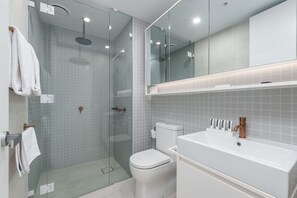 Shower, designer toiletries, hair dryer, towels