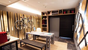A modern interior with a table, bench, and bicycles.