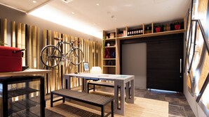 A modern interior with a bicycle, a table, and a bench.