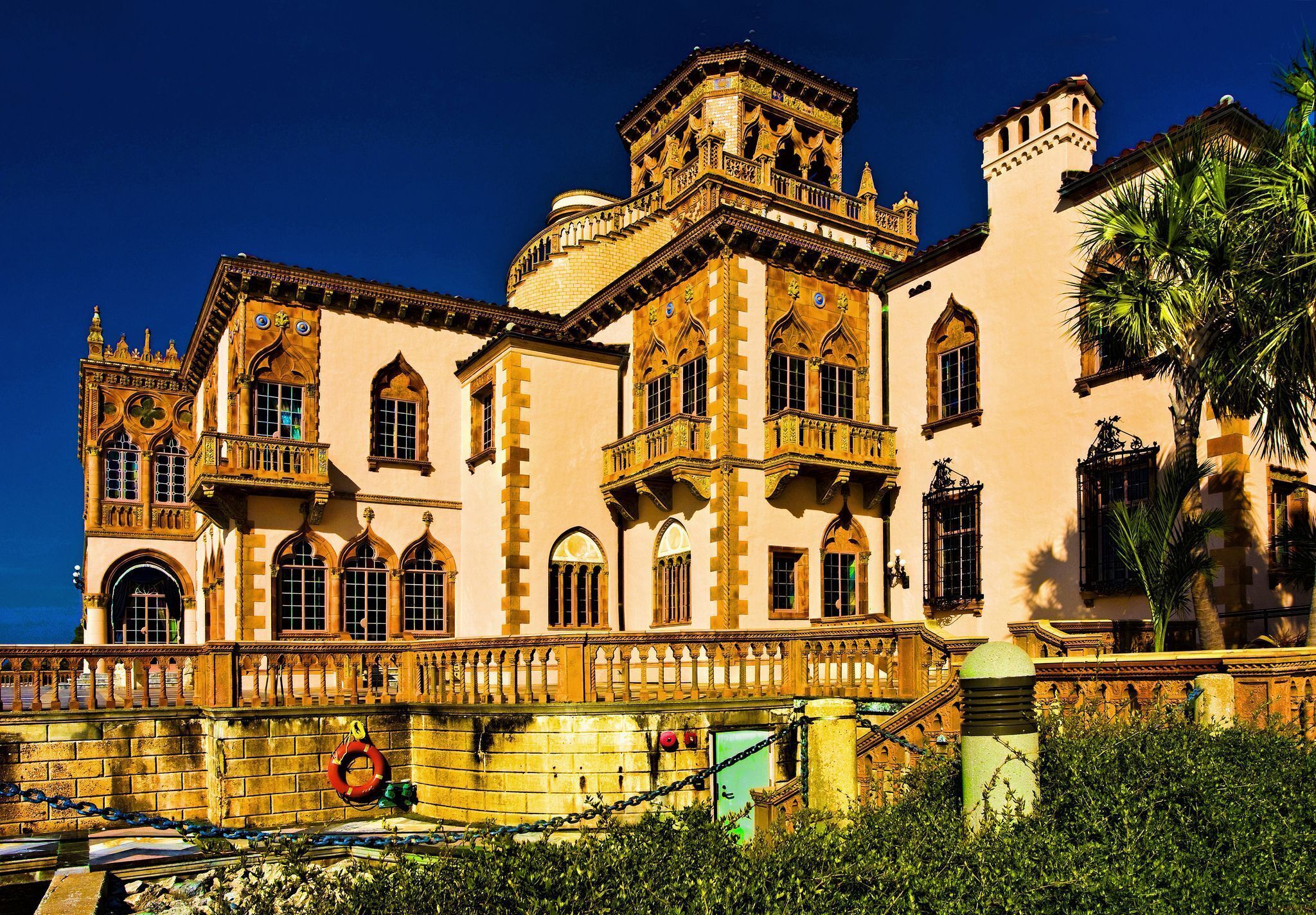 A historic building with multiple balconies, arched windows, and a prominent tower.